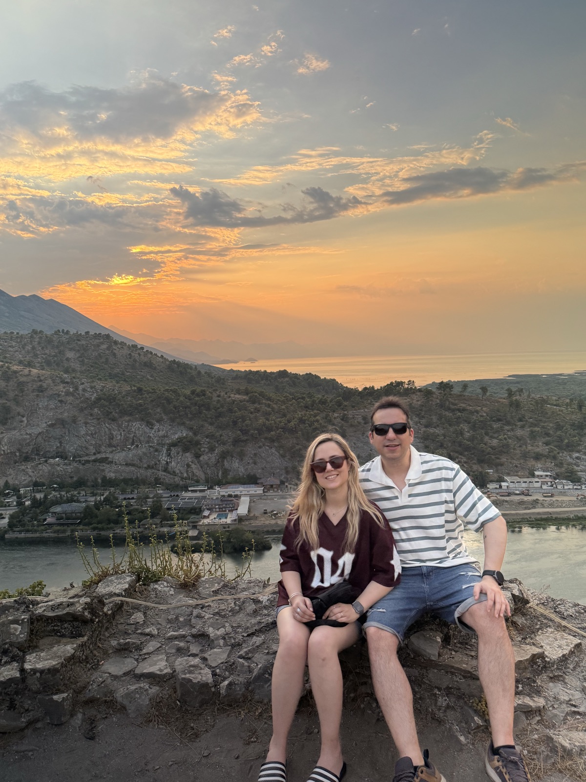 Carla and Gonzalo at a viewpoint overlooking the river and mountains at sunset in the Balkans